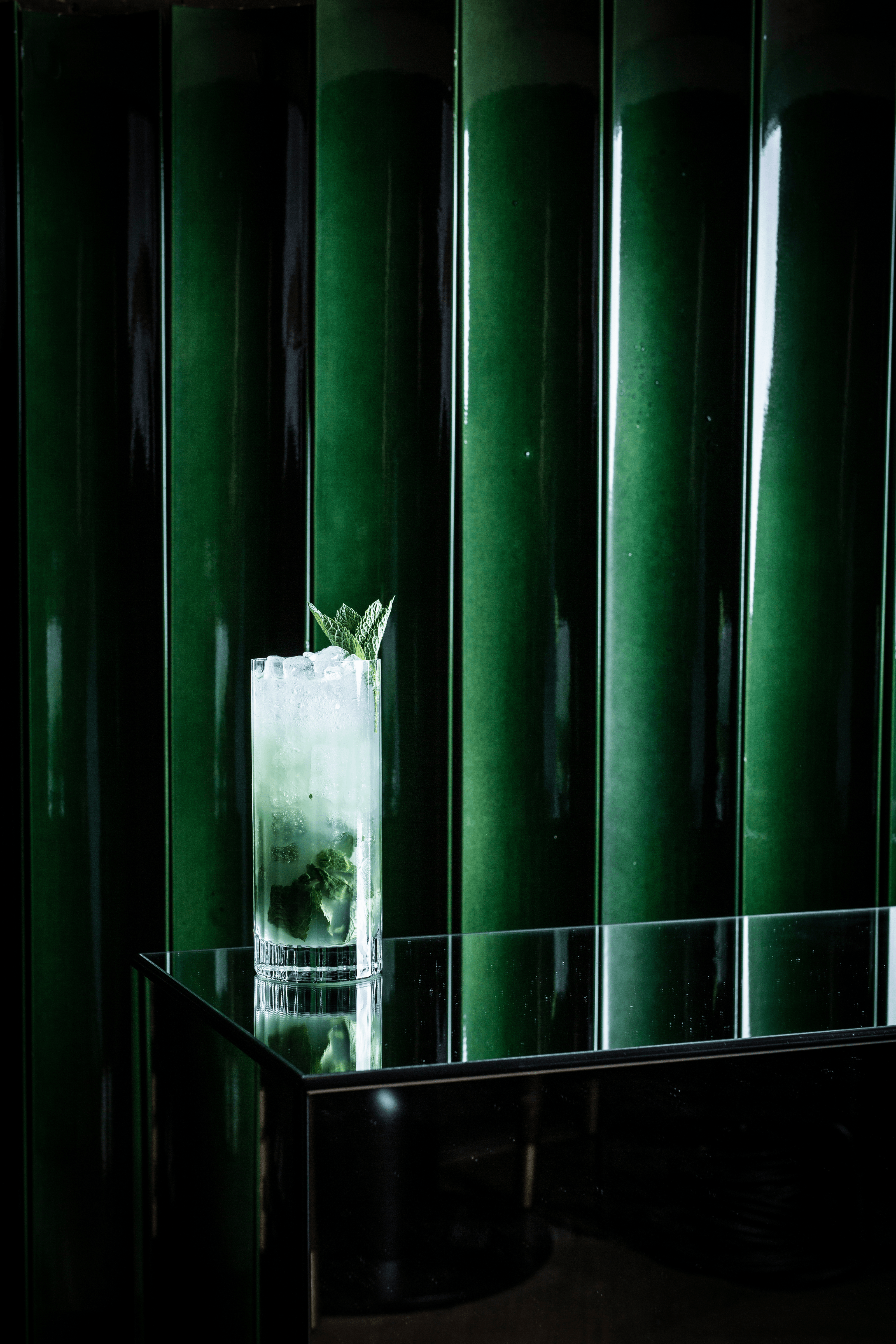 A Nomuss cocktail on a green background